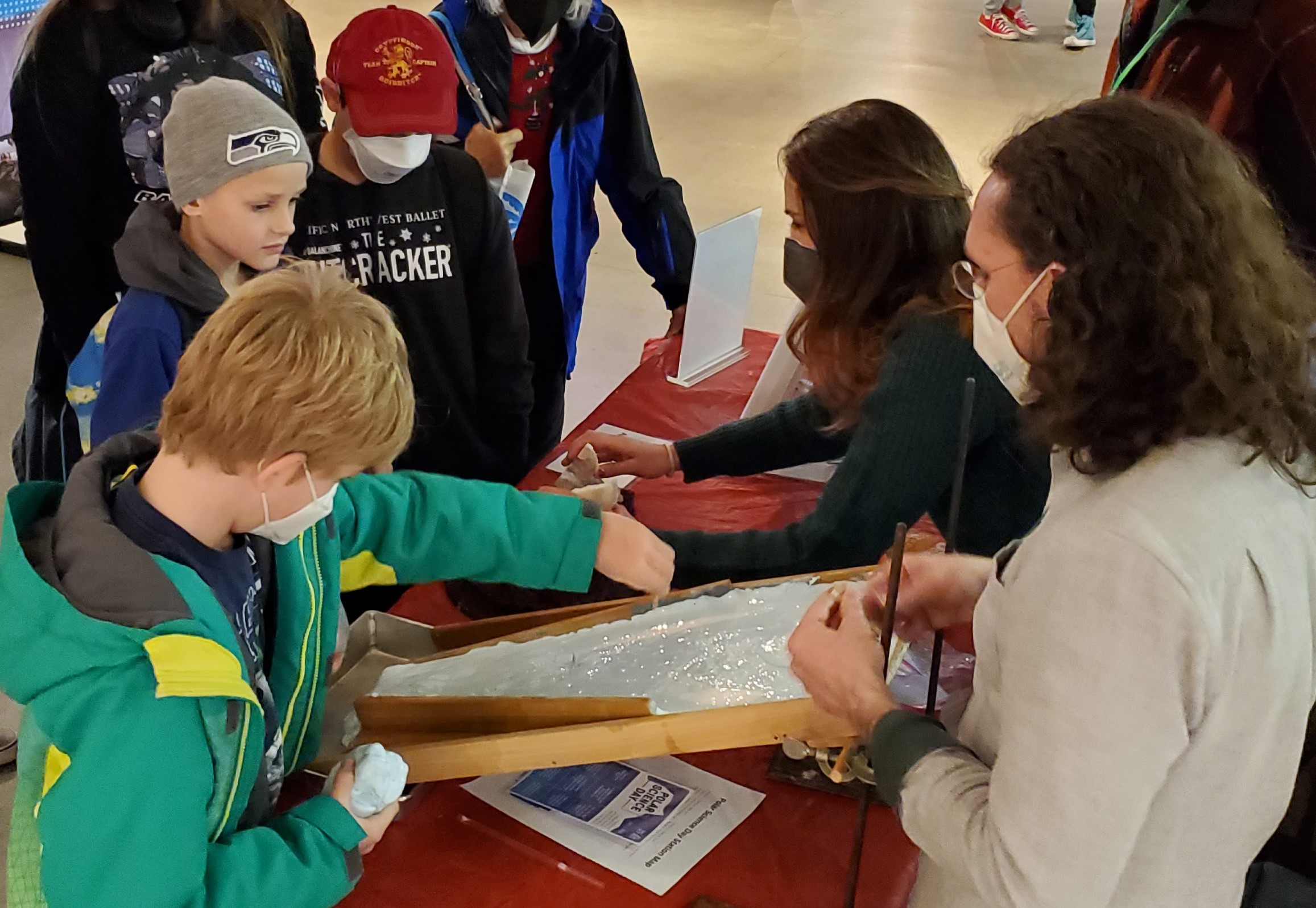 Polar Science Center investigators Michalea and Daniel Shapero demonstrate ice flow at Polar Science Day, Seattle.
